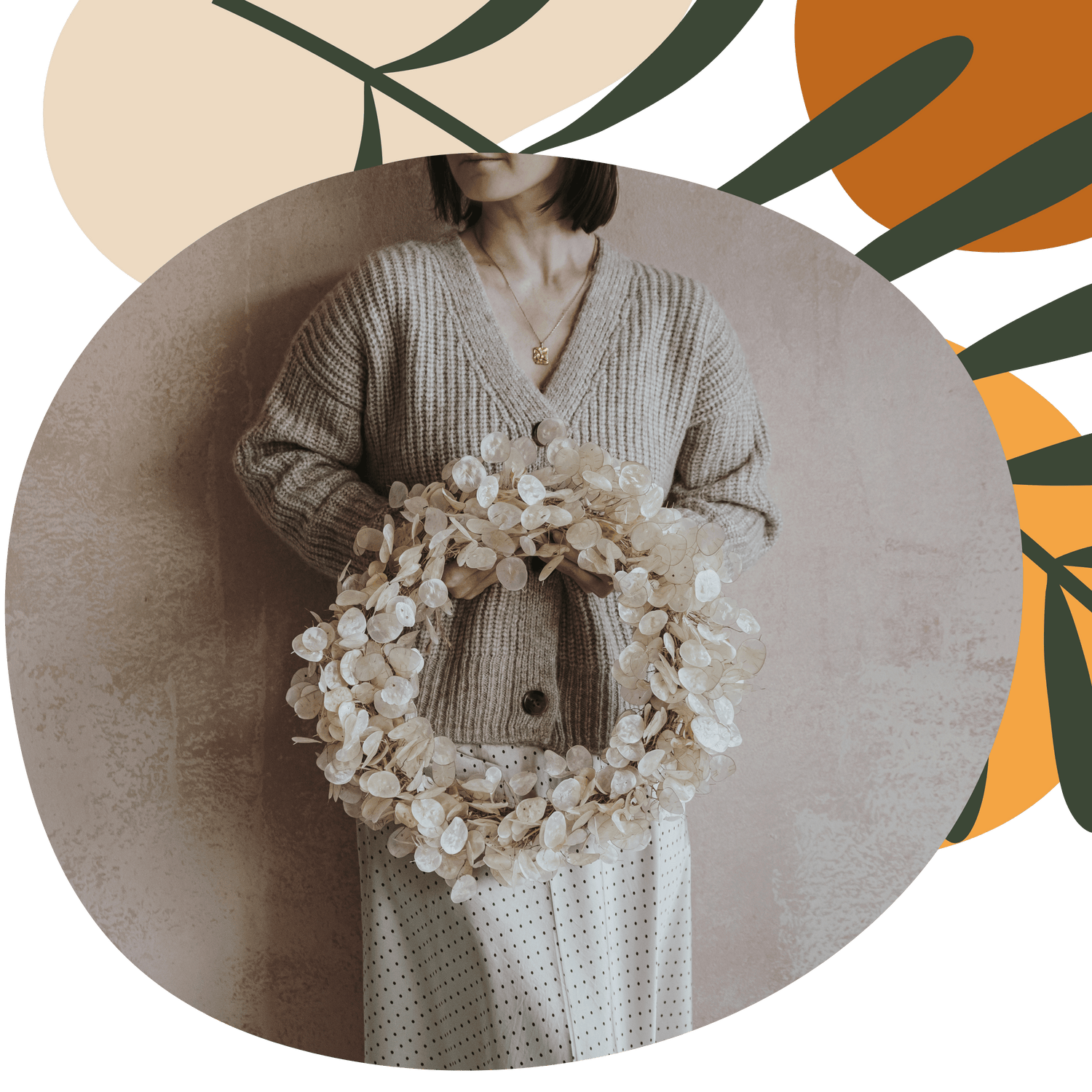 a woman holding a white preserved wreath