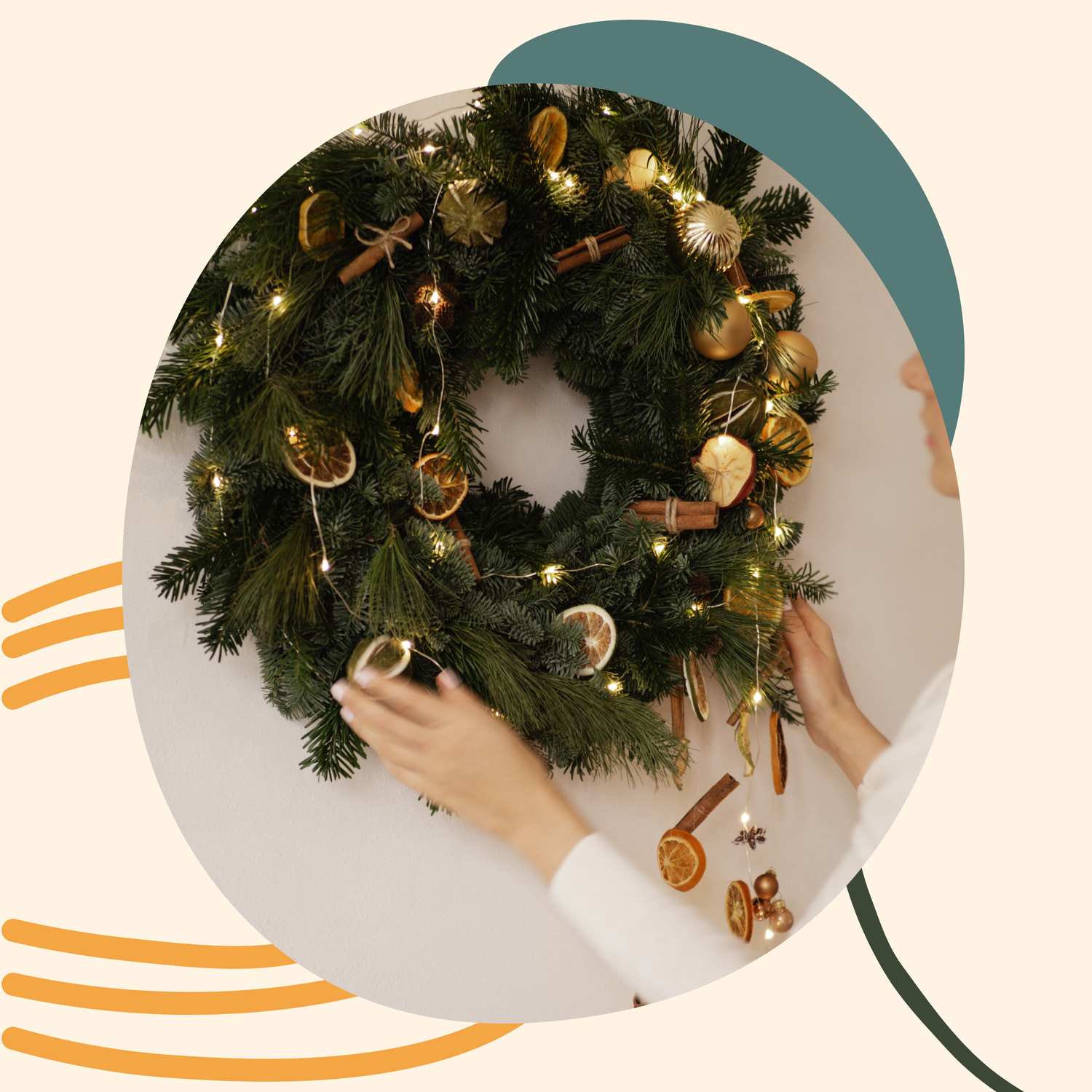 a woman putting an evergreen wreath with light string on the wall