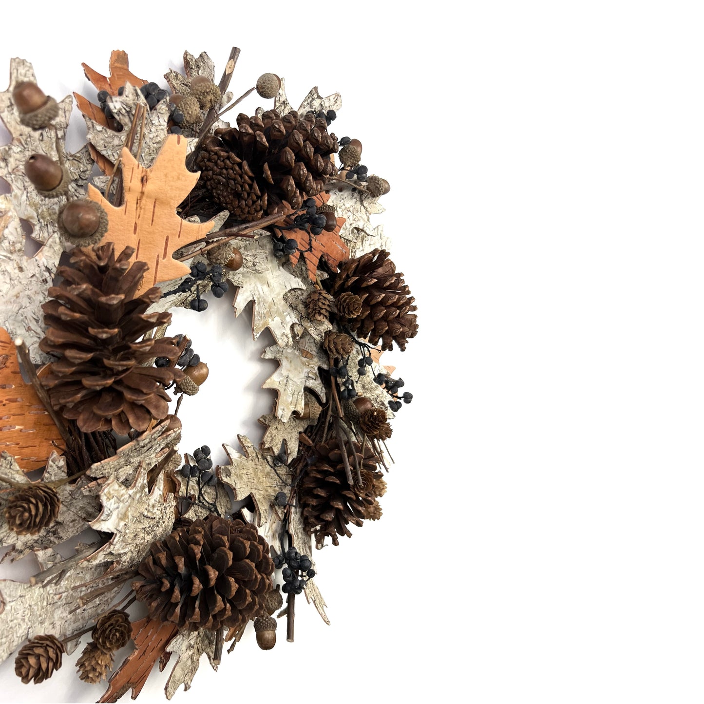 side view of the dried autumn wreath with pinecones acorns and birch barks