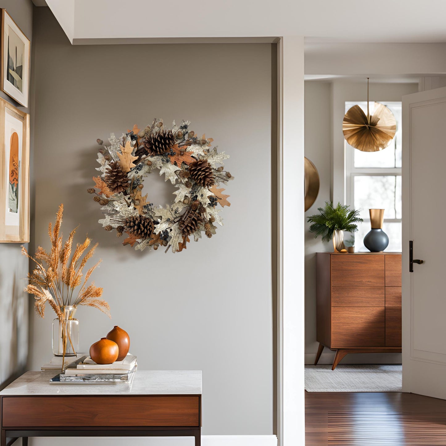 a handmade wreath with big pinecones on a beige wall in the foyer surrounded by neutral tone home decors