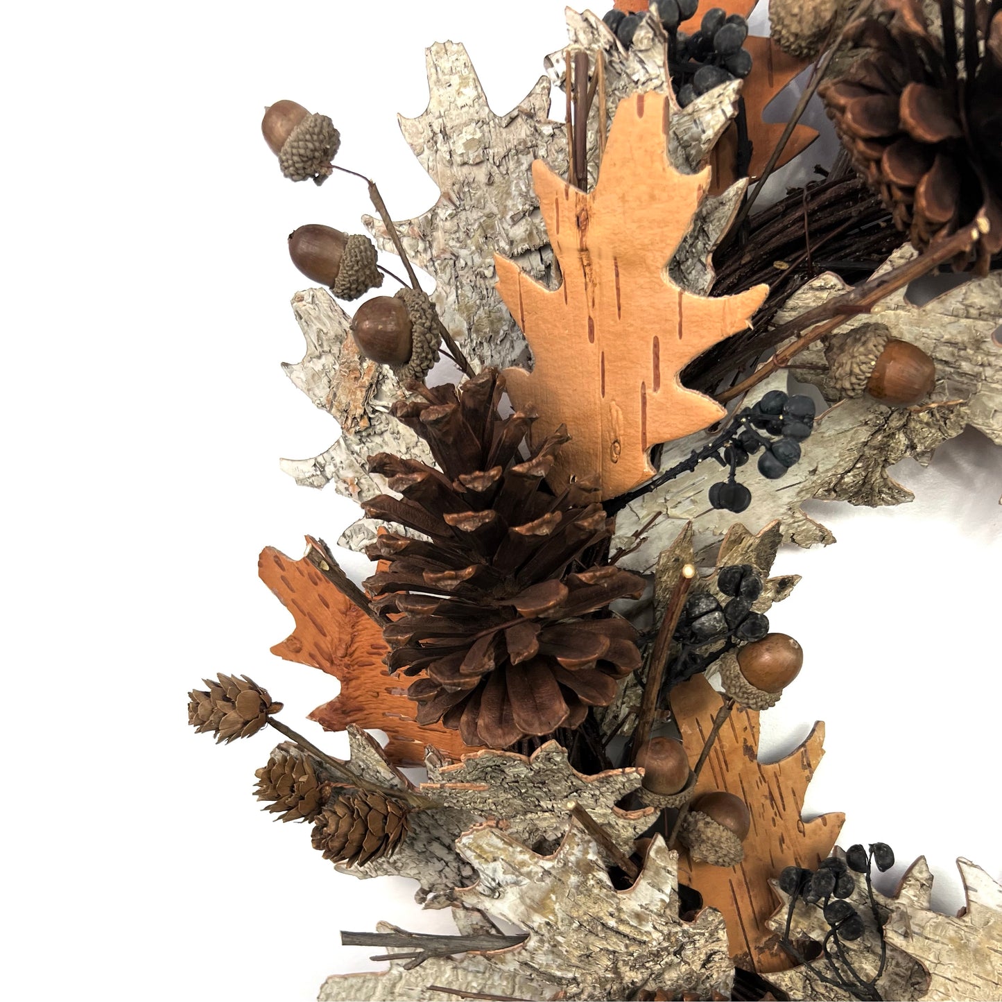 closeup view of dried fall wreath with pinecones and birch bark elements for thanksgiving decor