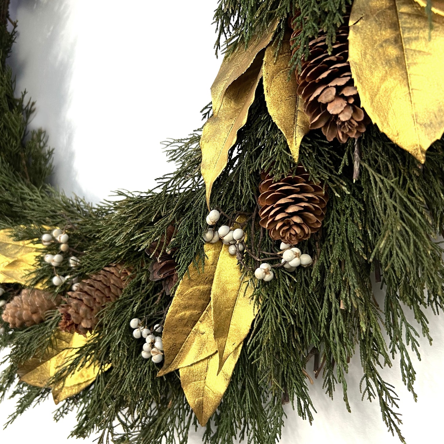 detailed view of the gold preserved olive leaves and tallow berries on the wreath