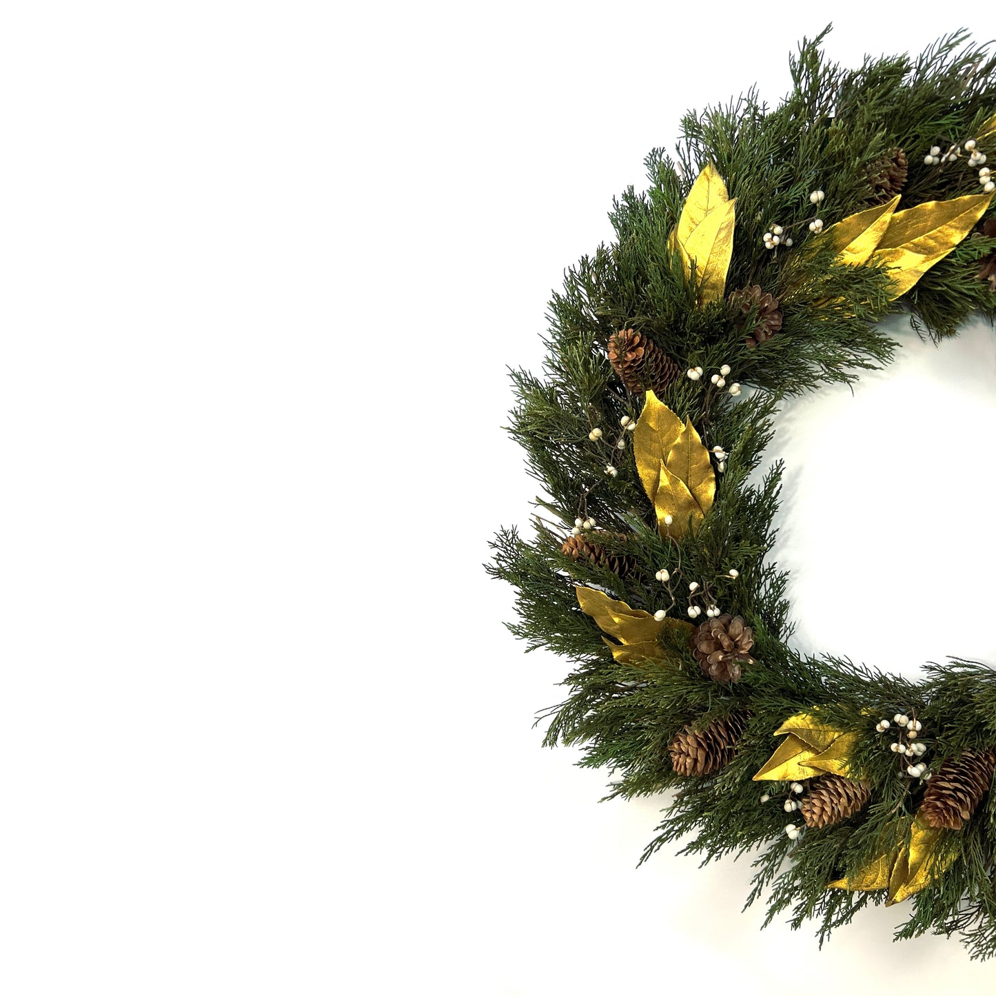 left side of the preserved juniper christmas wreath paired with gold olive leaves and pinecones