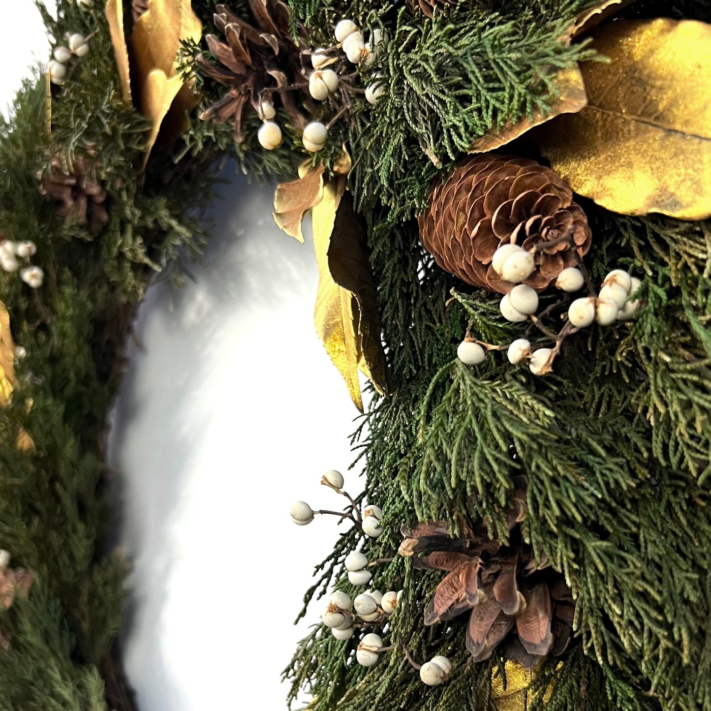 closeup look of large gold modern preserved christmas wreath