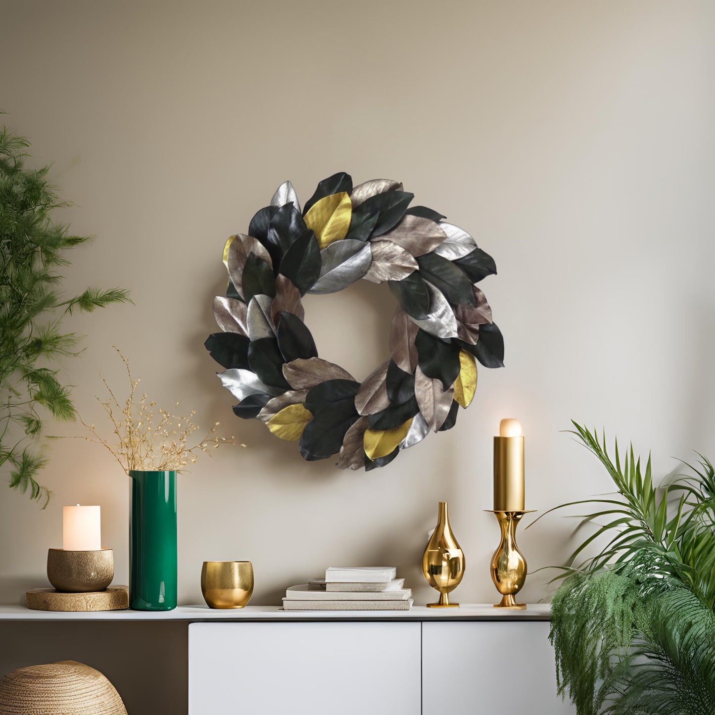 modern style preserved magnolia wreath hanging on top of a table with gold and green color decors on it