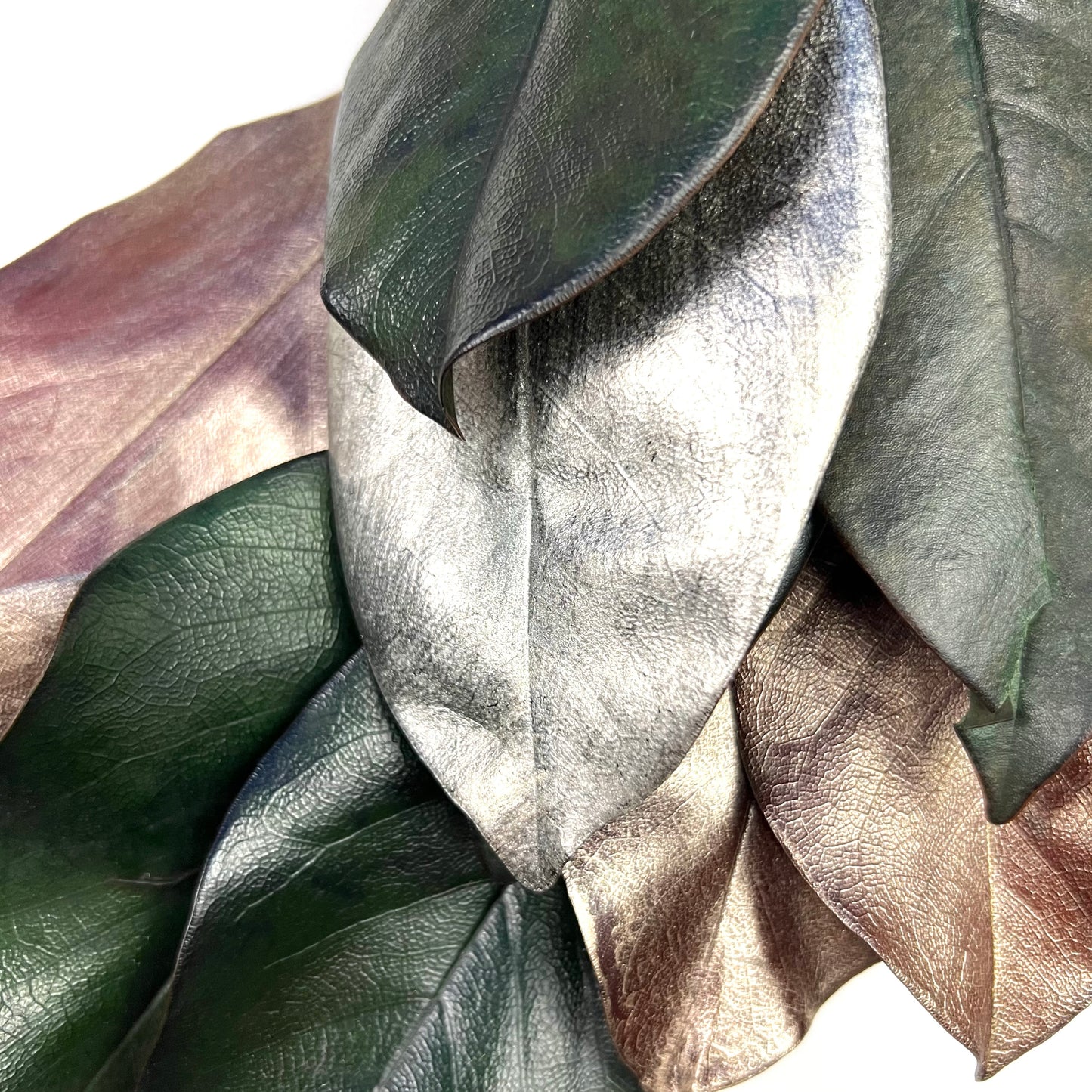 closeup look of the painted silver and copper tone magnolia leaves on the wreath