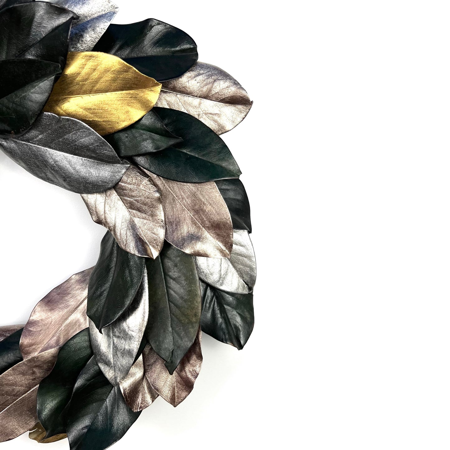 right side of the preserved magnolia wreath with hand-painted gold and silver leaves