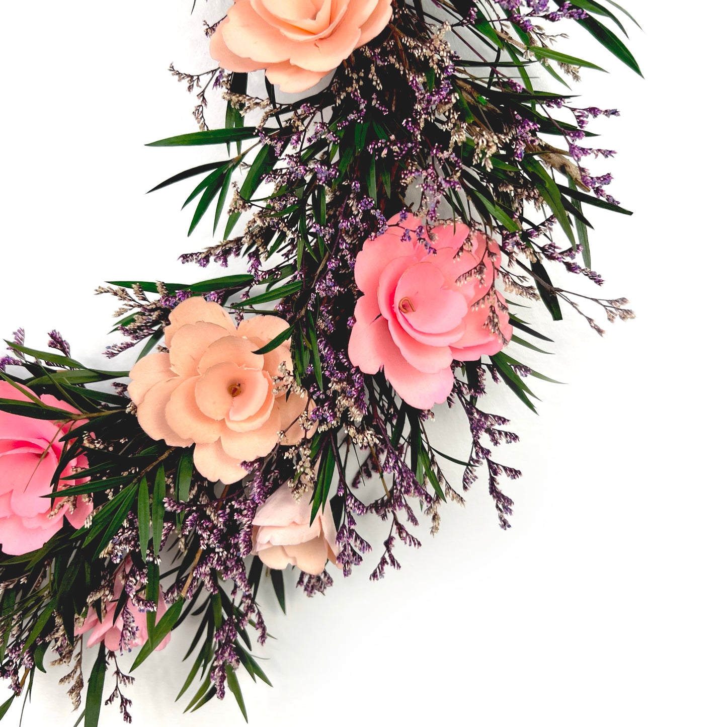Zoomed in view of the hand-crafted pink flowers made from thinly shaved birch wood