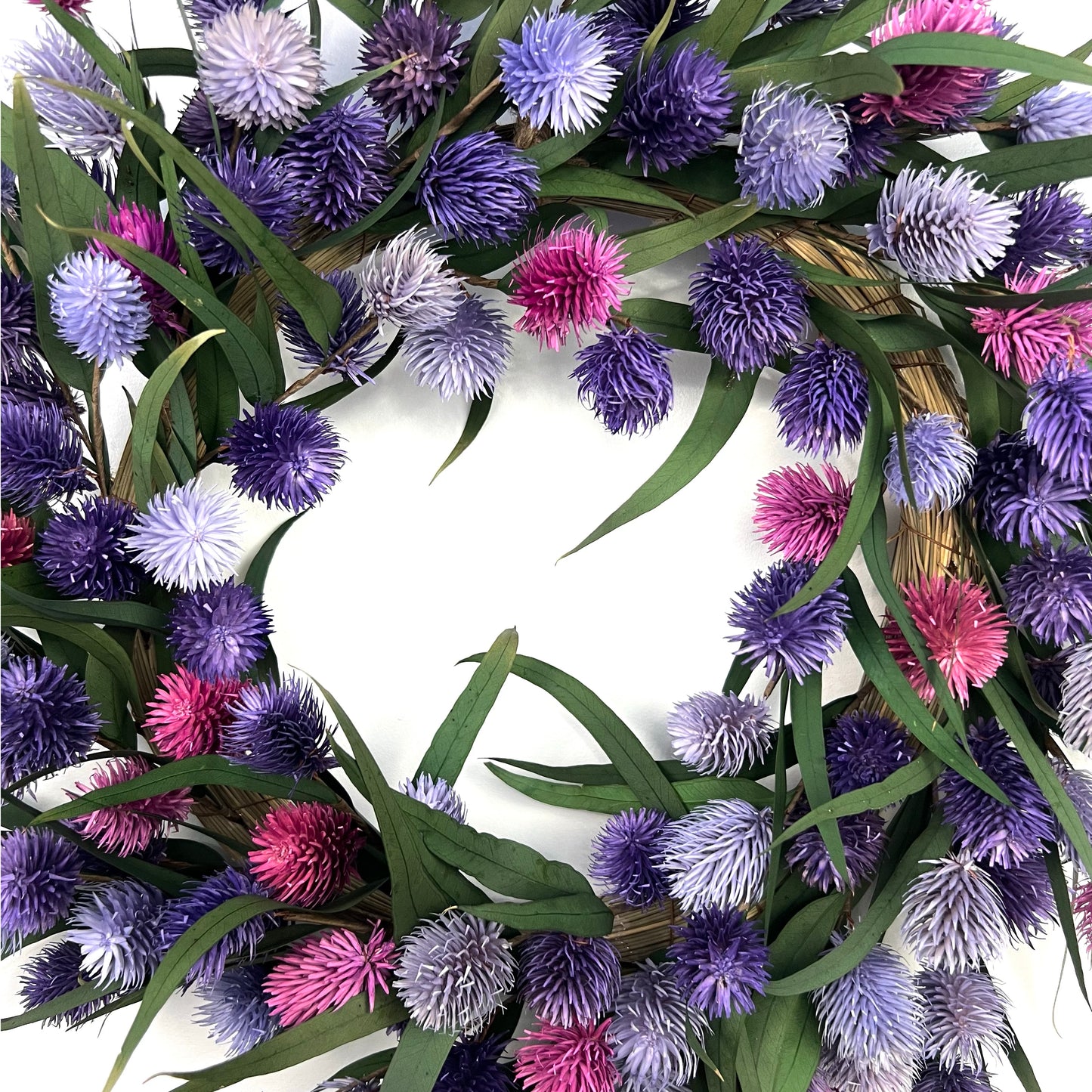 center of the preserved natural wreath with different shades of pink and purple color