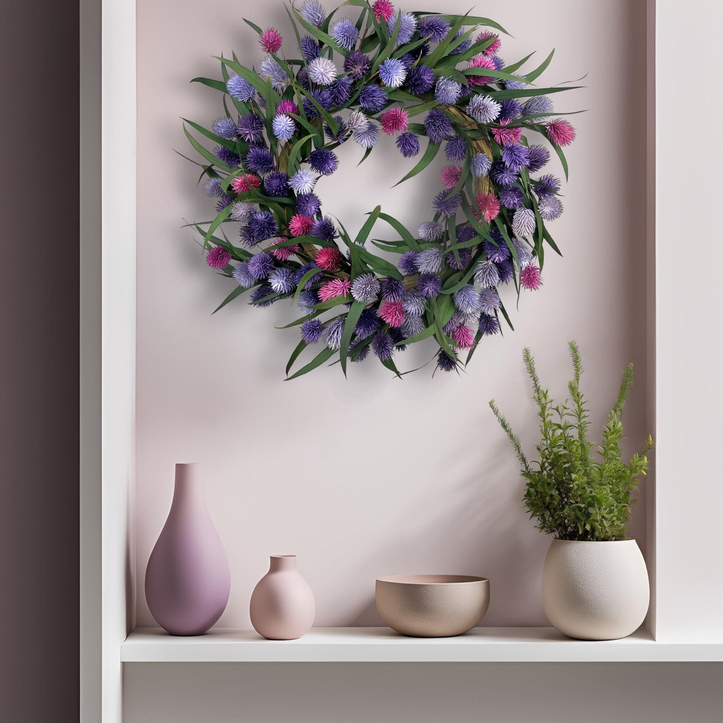 preserved handmade wreath with platycarya balls on a light pink wall on top of several vases and greeneries