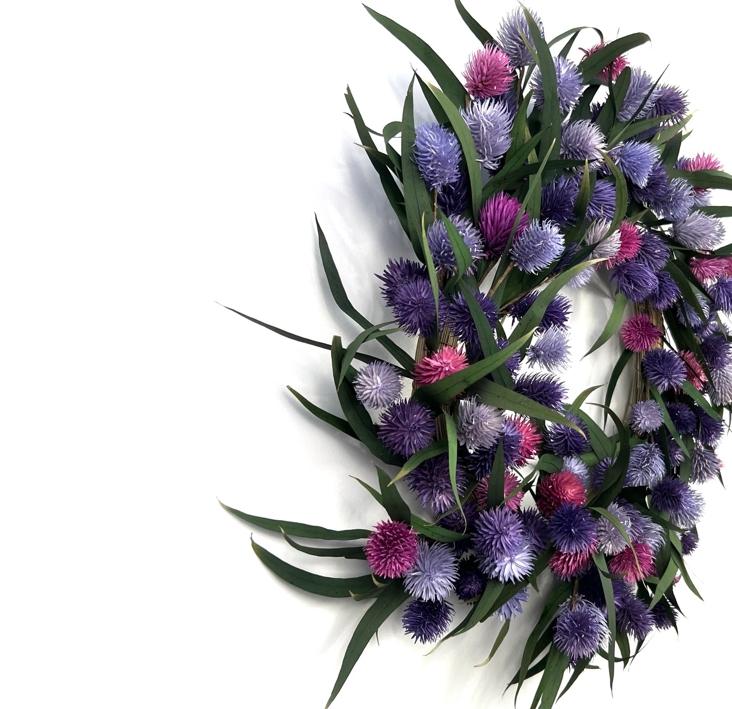 preserved natural eucalyptus wreath with purple platycarya on the wall