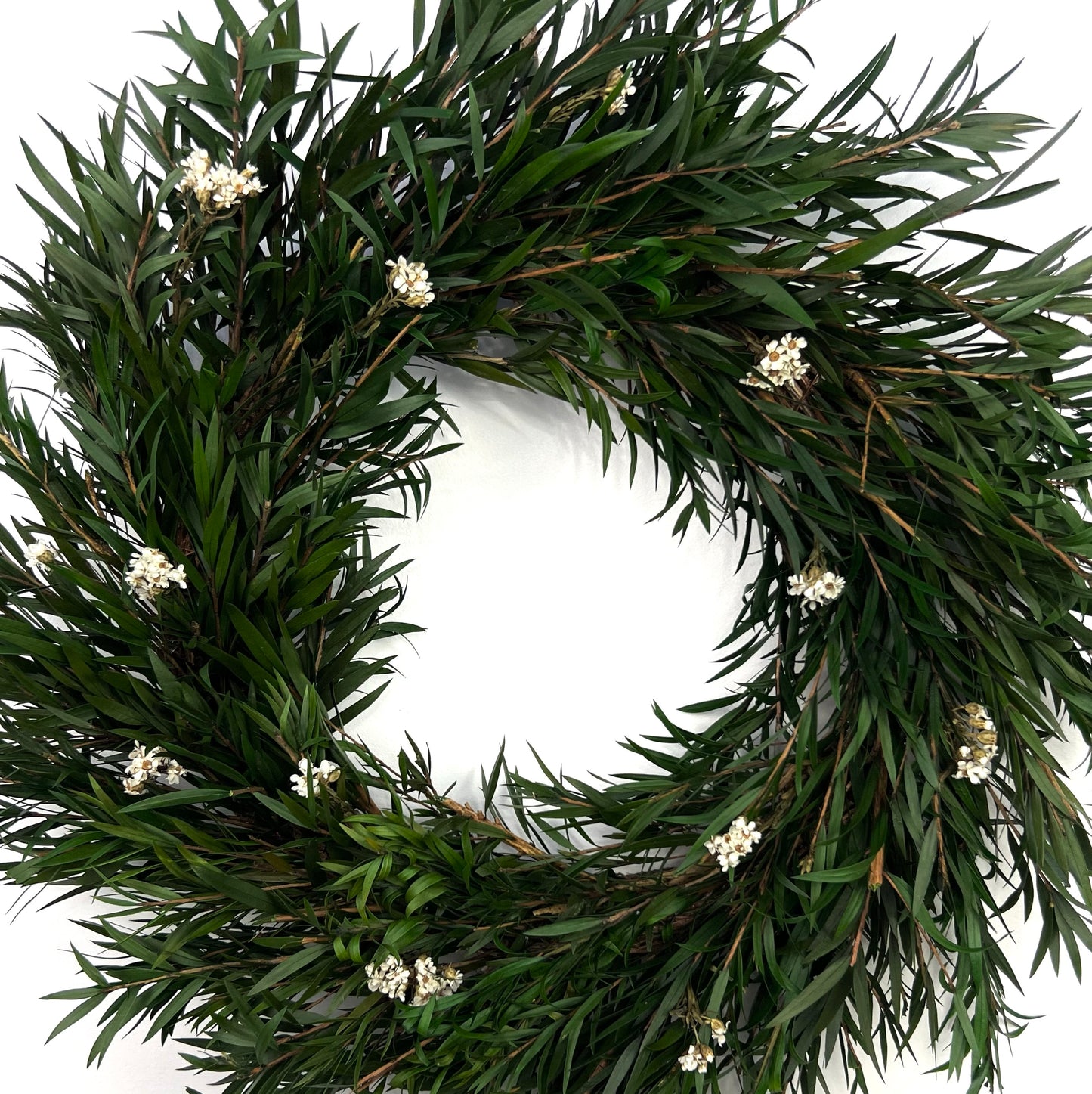 closer look at the vintage preserved holiday wreath accented by daisy flowers