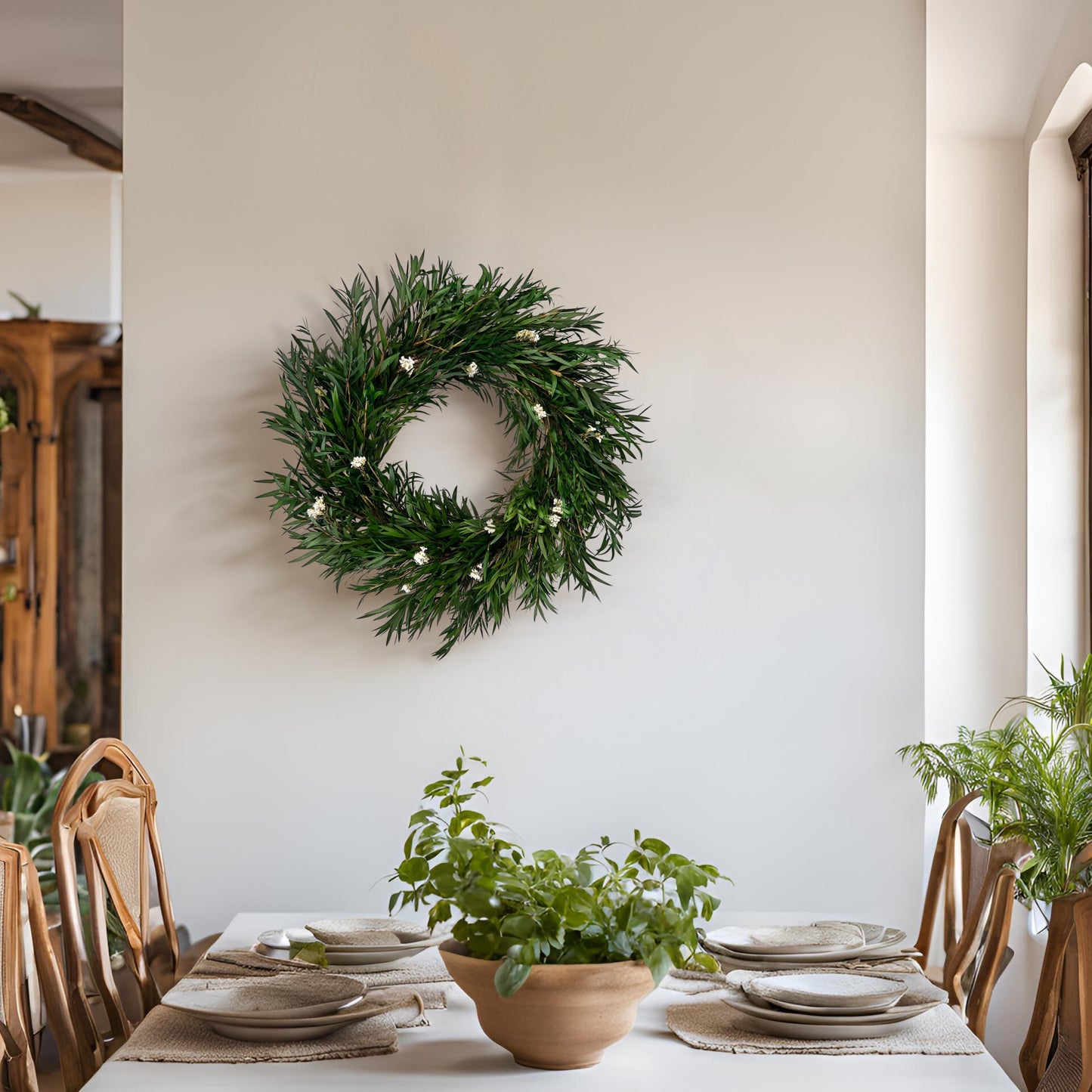 preserved handmade natural wreath with daisy flowers by a dining table with vintage table settings