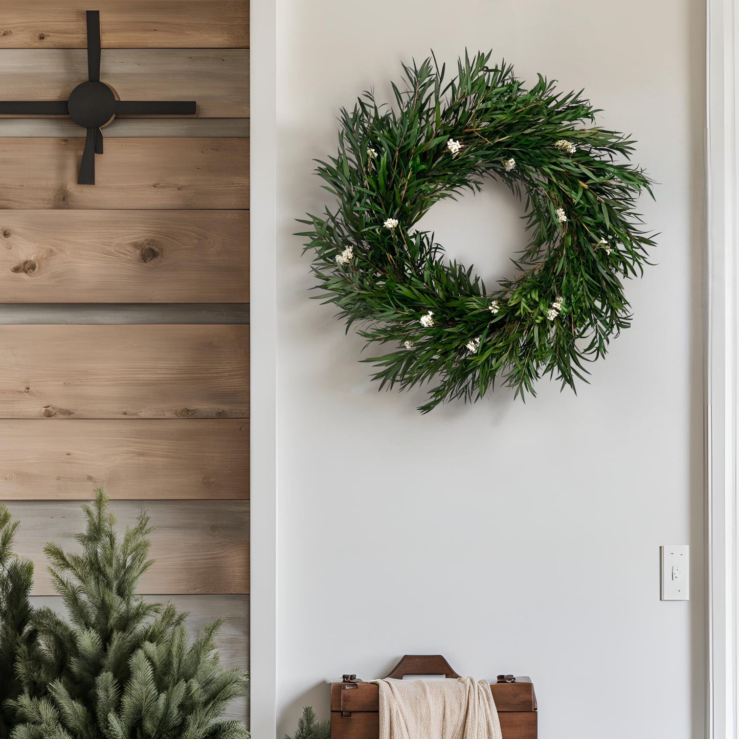preserved bottlebrush leaf wreath on a white wall surrounded by farmhouse decorations