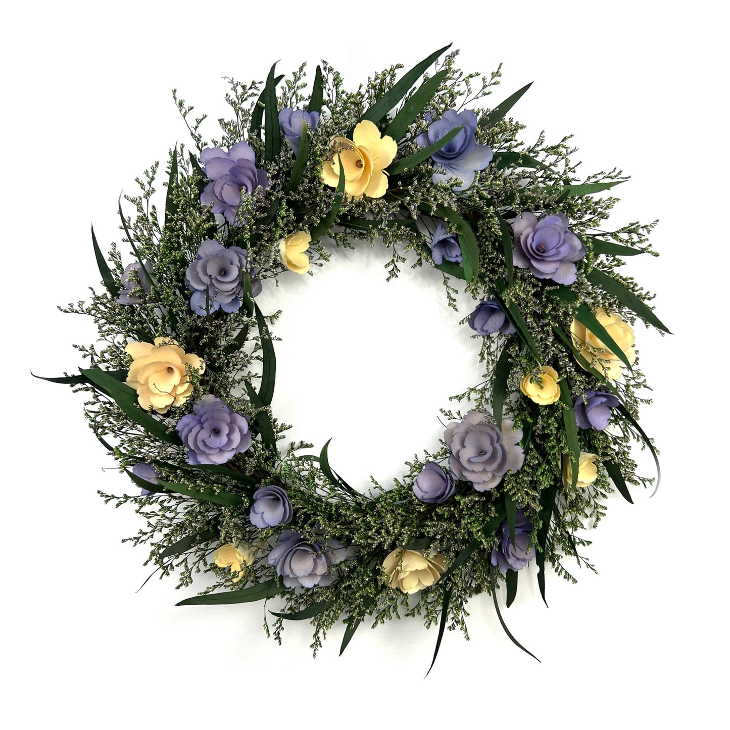 preserved eucalyptus wreath paired with pastel purple and white flowers ade from thin birch wood chips