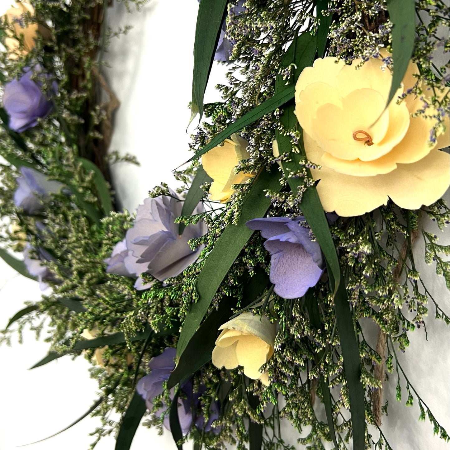detailed look of the flowers made from birch wood chips on the preserved wreath