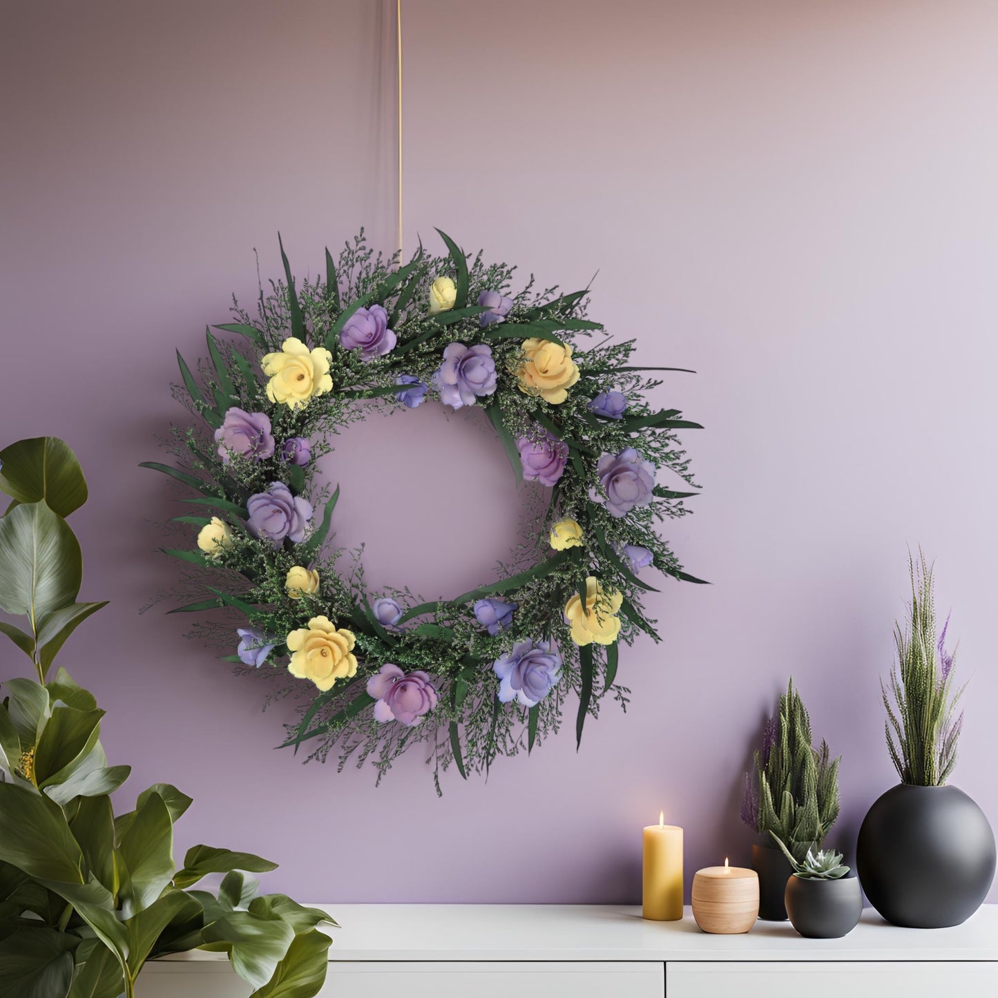 preserved purple and yellow spring wreath hanging on a pastel purple wall above a white cabinet with greenery and yellow candles on it