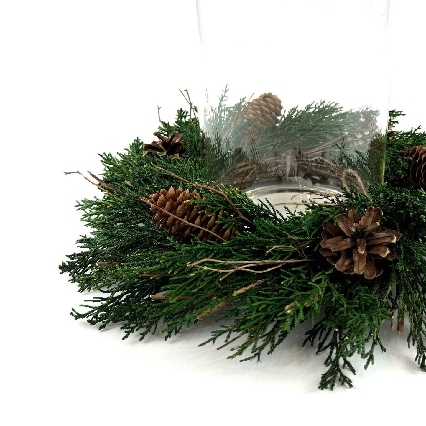small preserved foliage candle ring wreath with pinecones, twigs and juniper leaves as christmas centerpiece