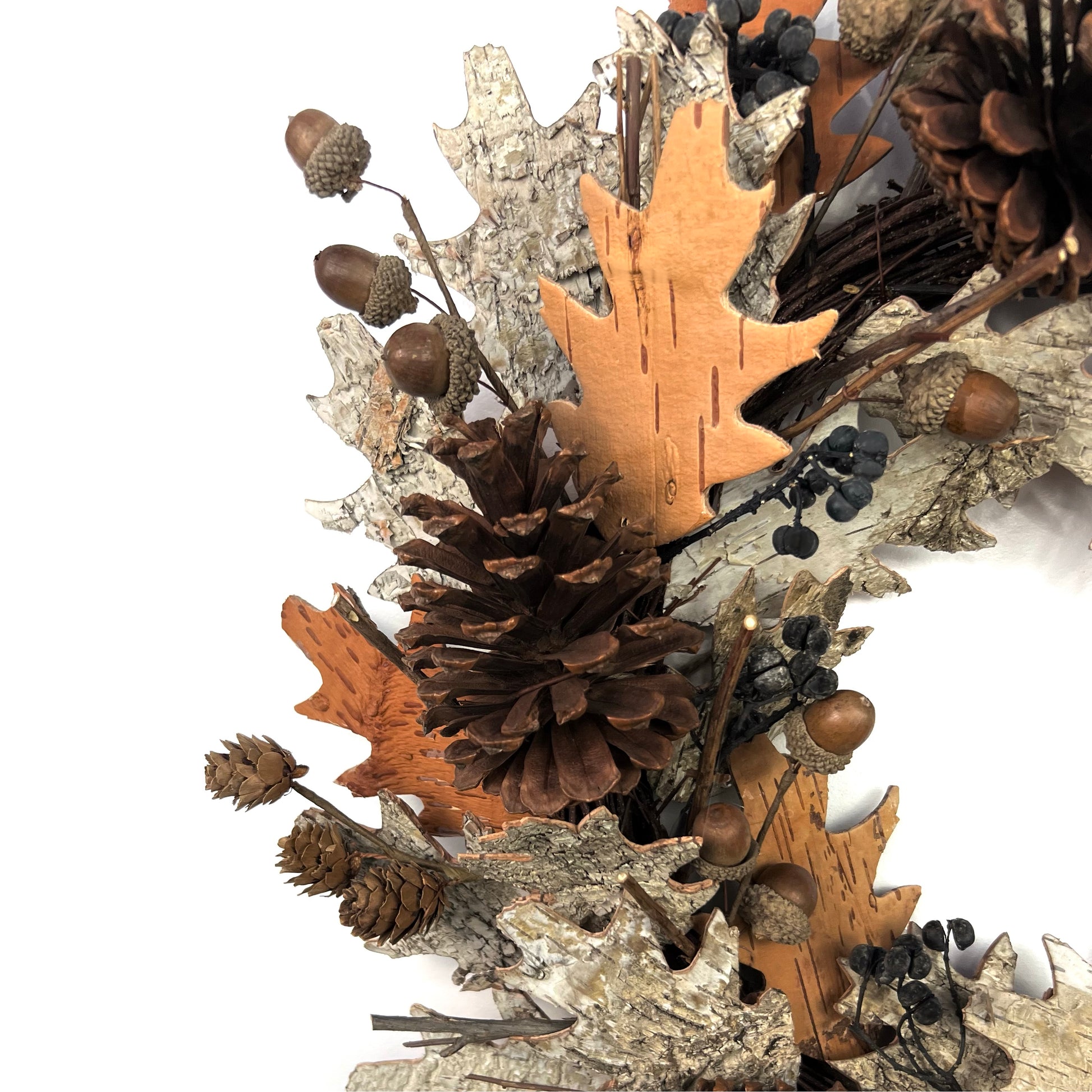 closeup view of dried fall wreath with pinecones and birch bark elements for thanksgiving decor