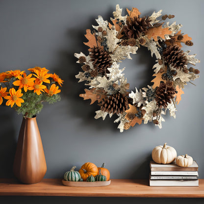 dried natural wreath on a grey wall on top of the wooden table with pumpkin decorations and orange flowers on it