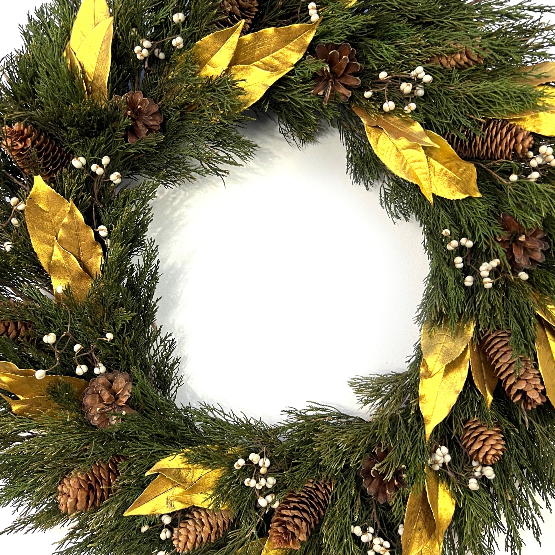 large preserved juniper wreath with luxurious gold and white accent decorated with pinecones