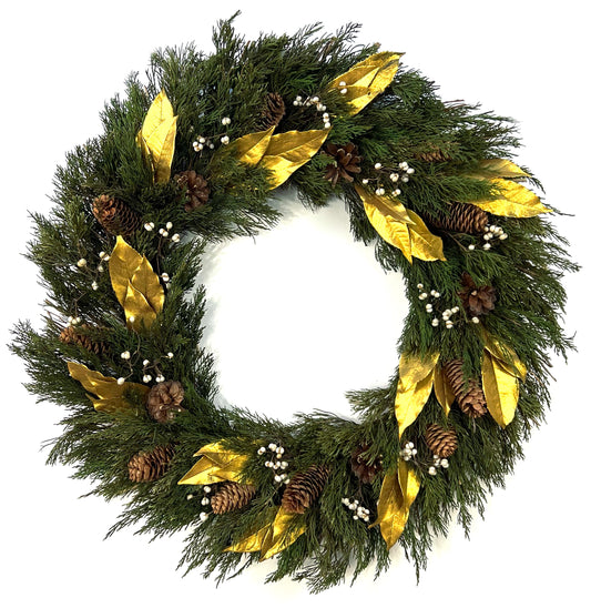 large christmas wreath with preserved juniper and olive leaves topped with pinecones and tallow berries