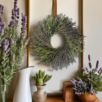 bohemian style preserved wreath  hanging above a wooden table with lots of lavender decors on it
