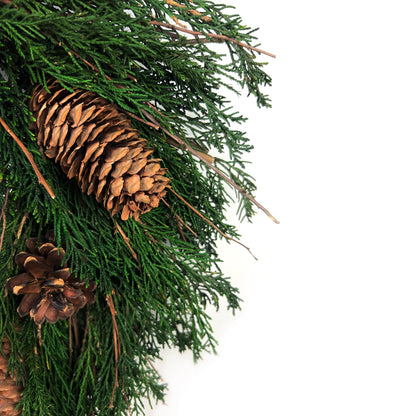 closeup look of the pinecones and twig elements on the preserved juniper wreath