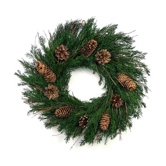 preserved juniper christmas wreath with pinecone decorations for vintage winter celebrations