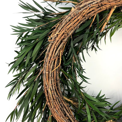 the back of the preserved bottlebrush leaf wreath made from dried pine twigs