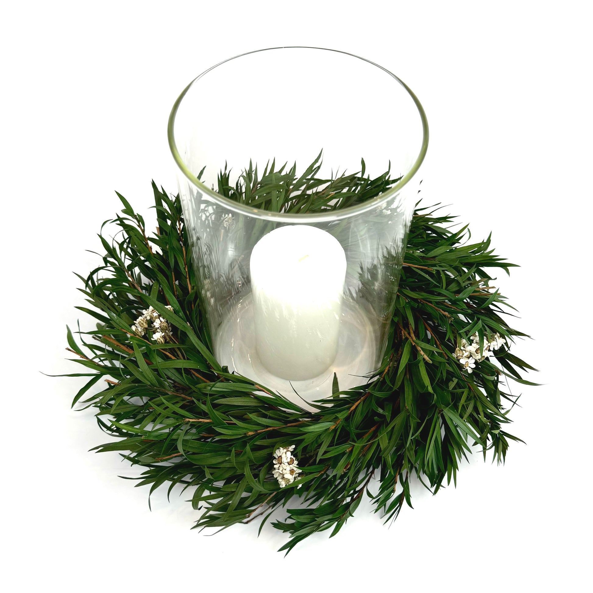 Top view of preserved candle ring wreath with daisy flowers around a glass candle  holder