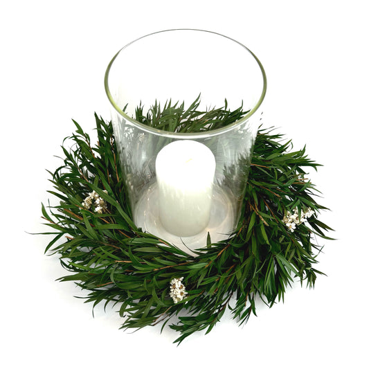 Top view of preserved candle ring wreath with daisy flowers around a glass candle  holder